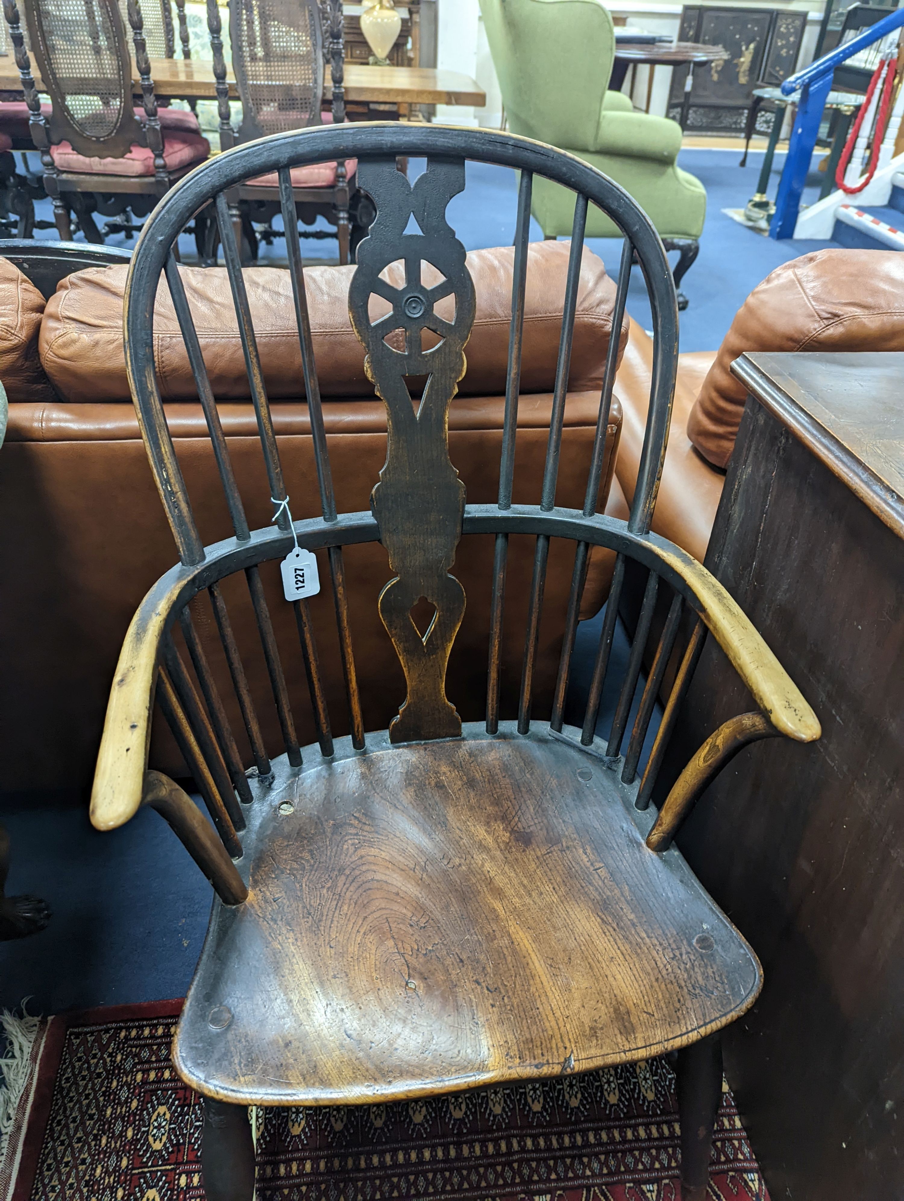 A 19th century elm and beech Windsor wheelback armchair, one leg a replacement, width 51cm, depth 41cm, height 101cm
